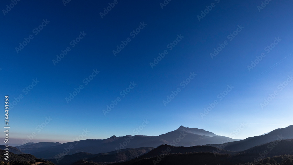 Solid blue sky on an outdoor scene mountain landscape