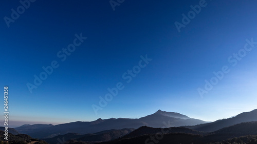 Solid blue sky on an outdoor scene mountain landscape