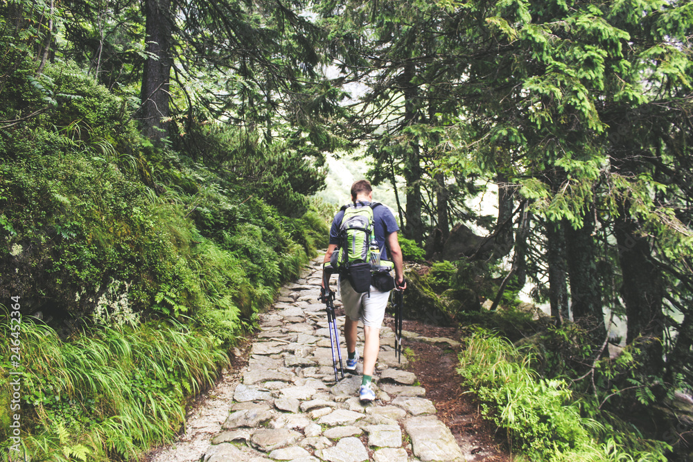 Happy hiker winning reaching life goal, success, freedom, achievement in mountains.