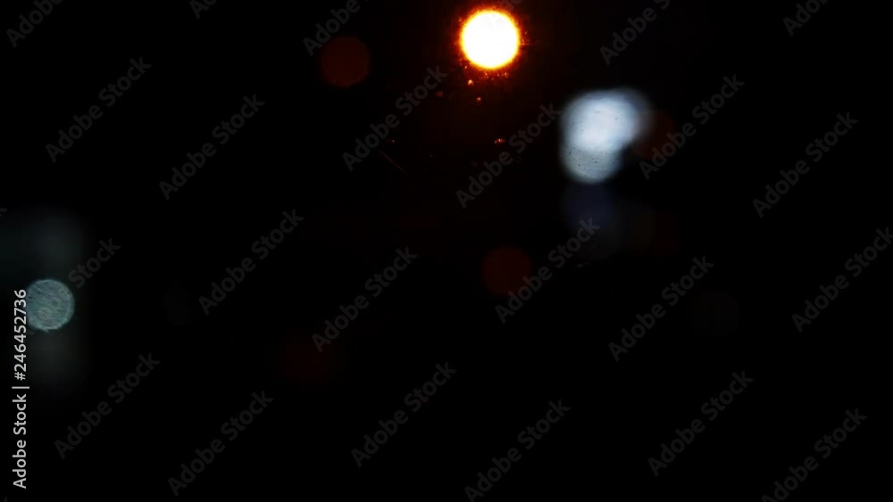 Moving bokeh circles from the lights of cars running on the city streets. City blur background. Night traffic. Moving bokeh circles from the lights of cars running on the city streets. City blur background. Night traffic.