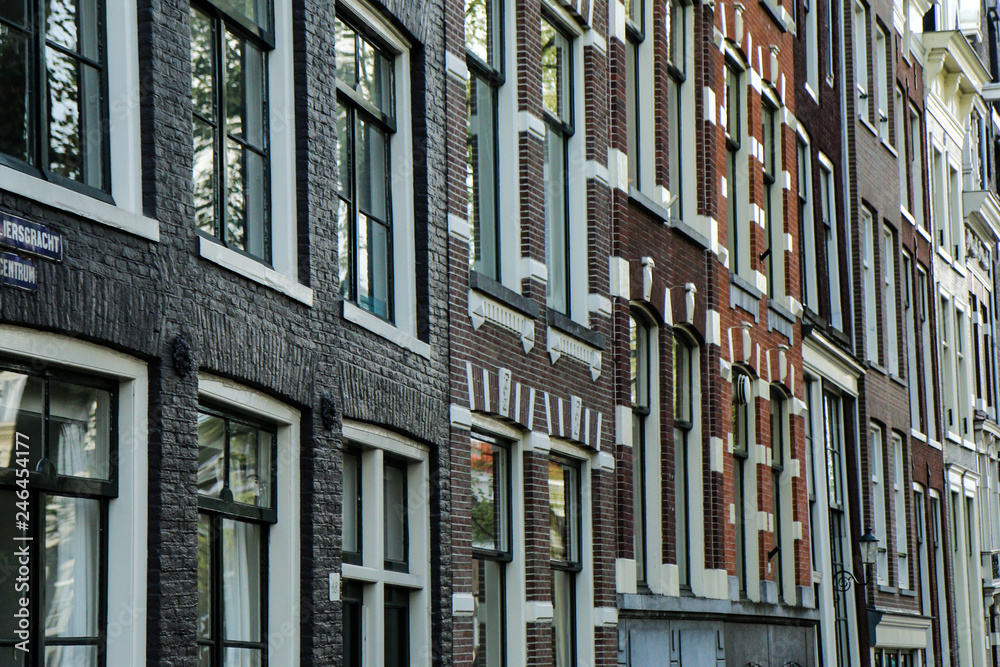 The detail of the houses in Amsterdam in Netherlands. The typical facades of the buildings. 
