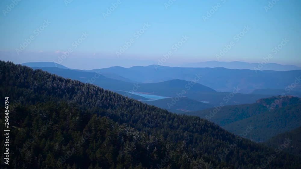blue lake between forest covered mountains blue lake between forest covered mountains