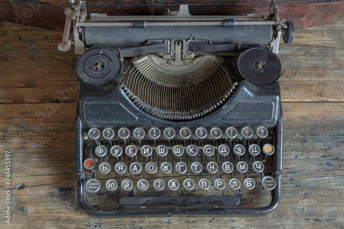The old rusty writing machine on a wooden table