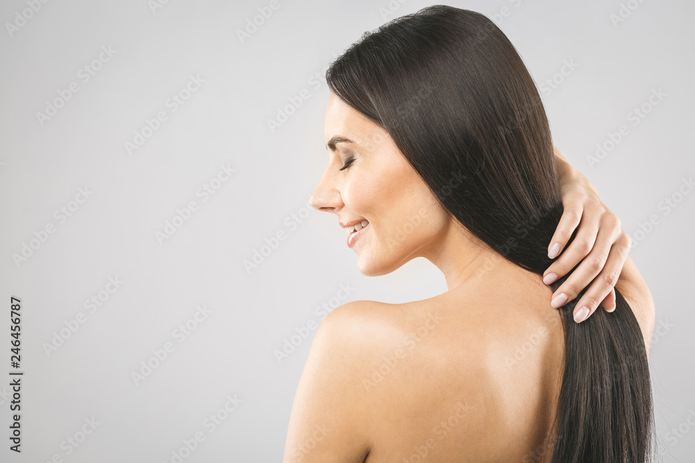 Beautiful brunette girl with long and straight brown hair. Shiny smooth and healthy well-groomed hair. Isolated over white background. Beautiful brunette girl with long and straight brown hair. Shiny smooth and healthy well-groomed hair. Isolated over white background.