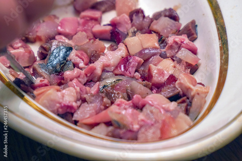 Sliced fish meat for salad. Finely chopped fish photo