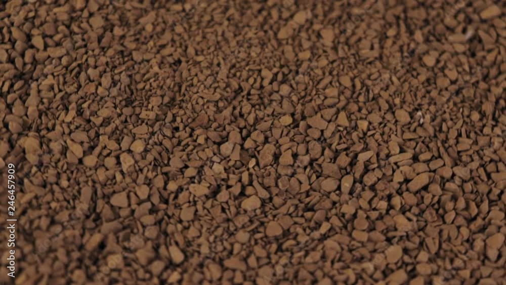 Granulated instant coffee rotating background, slow motion Granulated instant coffee rotating background, slow motion