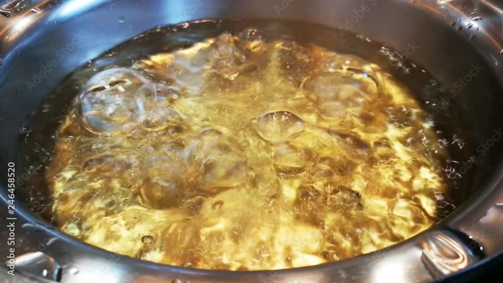The soup in the pot is boiling in a restaurant. The soup in the pot is boiling in a restaurant.