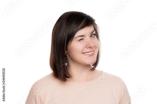 Foto Portrait of a beautiful woman blinking eyes, isolated on white