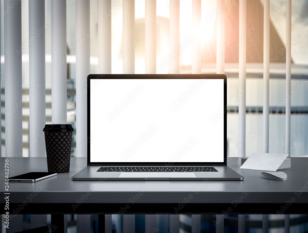 Laptop with blank screen on table in skyscraper office interior building - mockup, template Laptop with blank screen on table in skyscraper office interior building - mockup, template