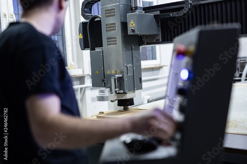 Plakat CNC operator while programming machine 