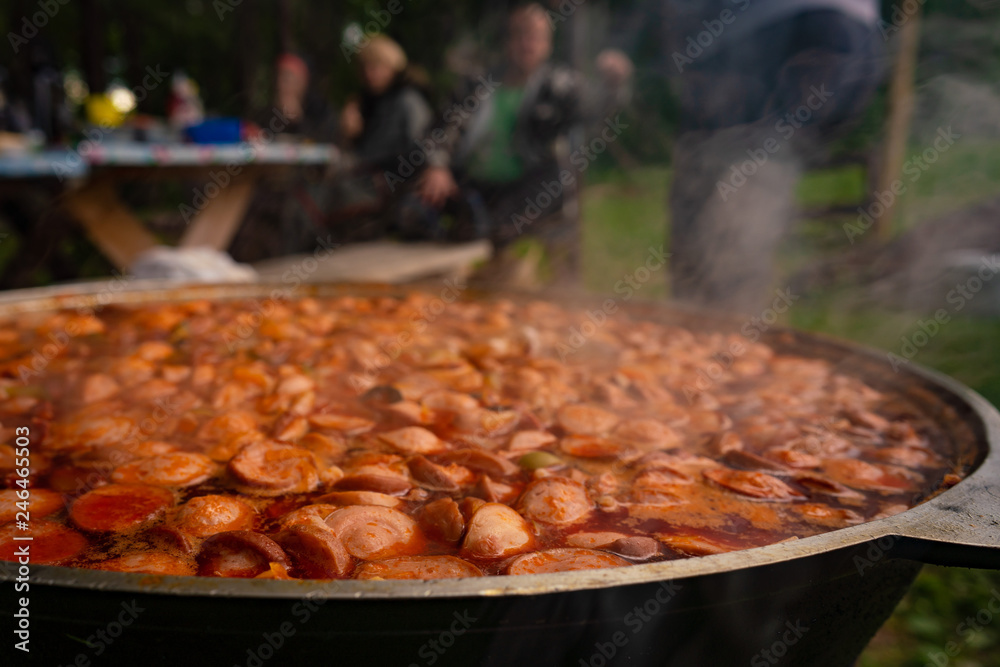 Cooking Russian soup Solyanka in a cauldron outdoor Cooking Russian soup Solyanka in a cauldron outdoor