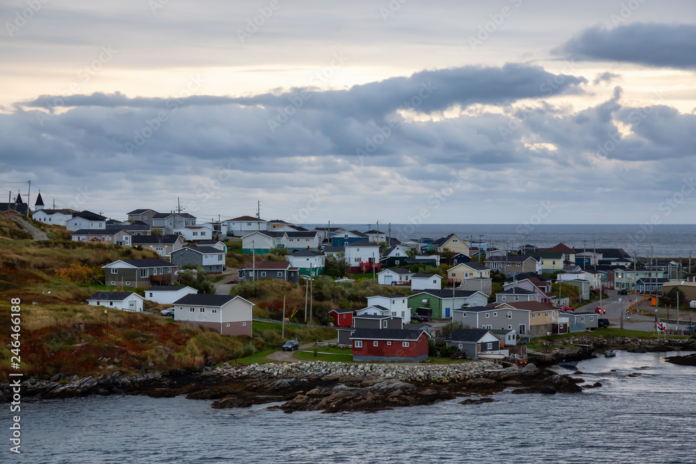 Homes in a little town on the rocky Atlantic Ocean Coast during a cloudy sunset. Taken in Channel-Port aux Basques, Newfoundland, Canada.