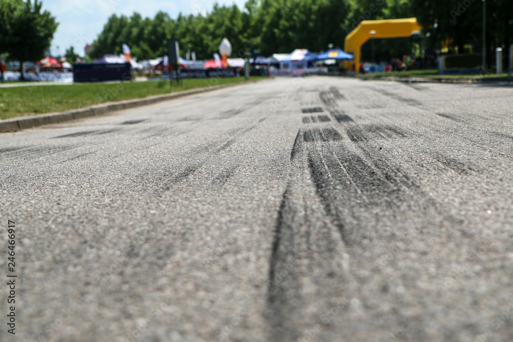 Obraz premium The rubber tracks from the rallye cars left on the tarmac in the hairpin.