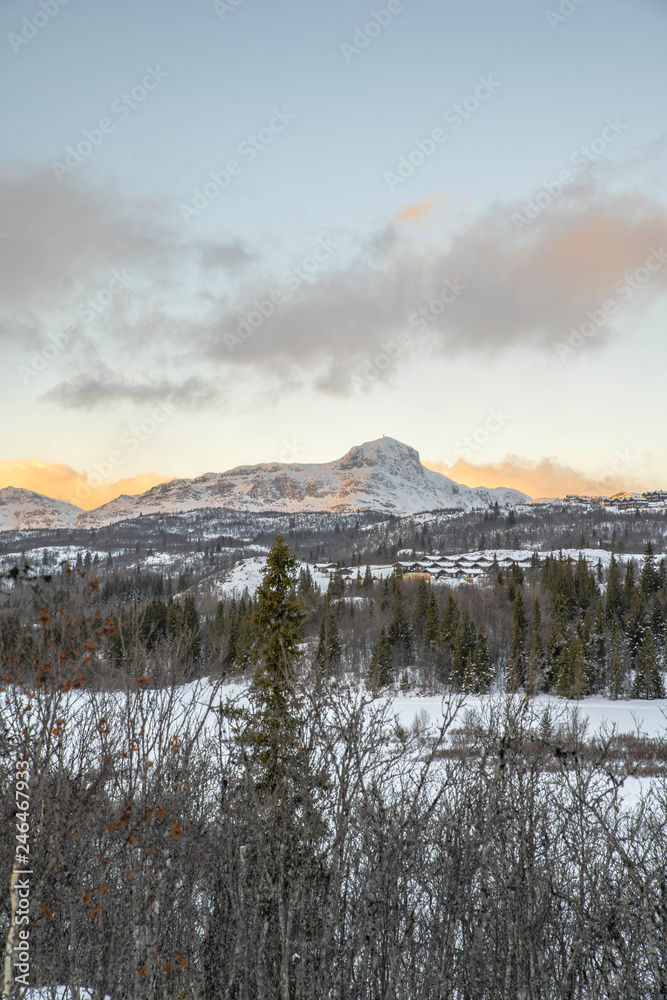 Bitihorn mountain in Norway vew from Beitostølen at sunset in winter with a lot of snow.
