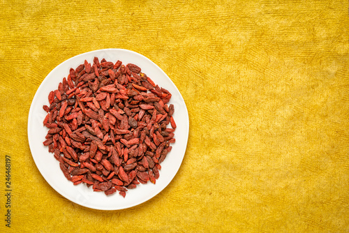 dried goji berries on a white plate