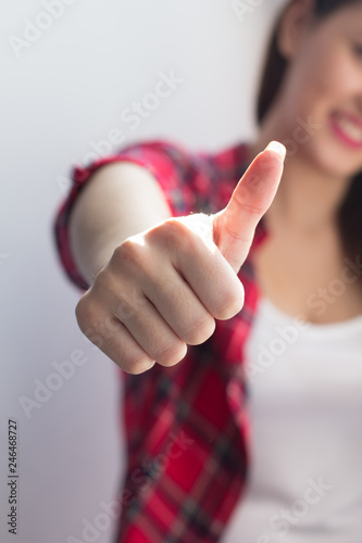 Girl showing thumb up.