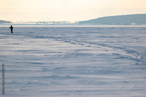 Man on a winter landscape doing Nordic walking