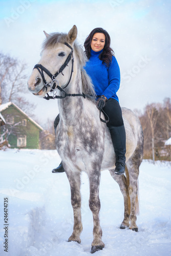 a young woman with a beautiful winter white horse