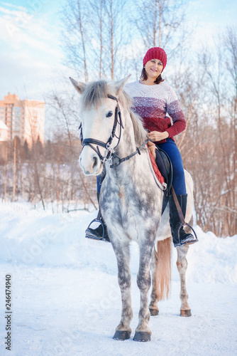 young beautiful woman in winter with beautiful white horse © Екатерина Переславце