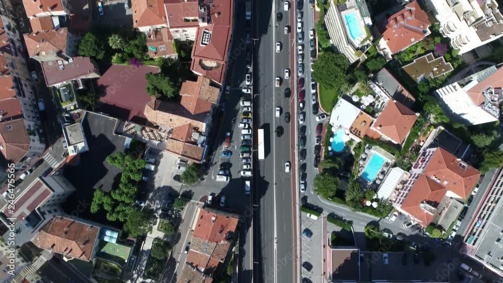 Aerial top down view from helicopter moving over public road with traffic and real estate on left and right side of streets then later showing railway emerging from underground 4k high resolution