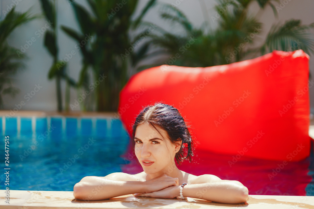 brunette girl relaxing in the pool