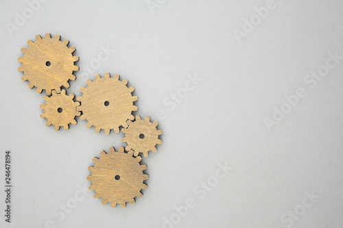 Vertical gear wheels composition on grey background with copy space photo