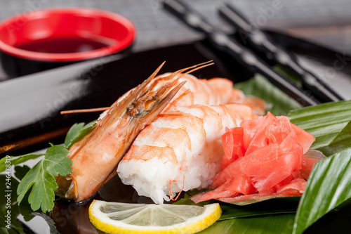 Japanese national popular cuisine. Sushi, rice and fish. Tasty, beautifully served food in a restaurant, cafe, with elements of the original design.