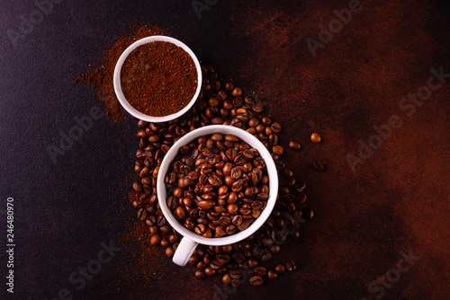 Seeds of fragrant coffee, coffee drink on a dark concrete background. It can be used as a background