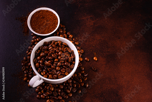 Seeds of fragrant coffee, coffee drink on a dark concrete background. It can be used as a background