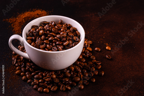 Seeds of fragrant coffee, coffee drink on a dark concrete background. It can be used as a background