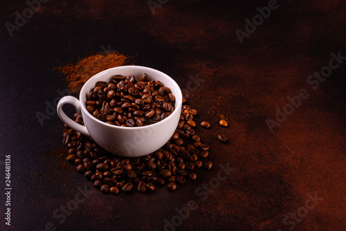 Seeds of fragrant coffee, coffee drink on a dark concrete background. It can be used as a background