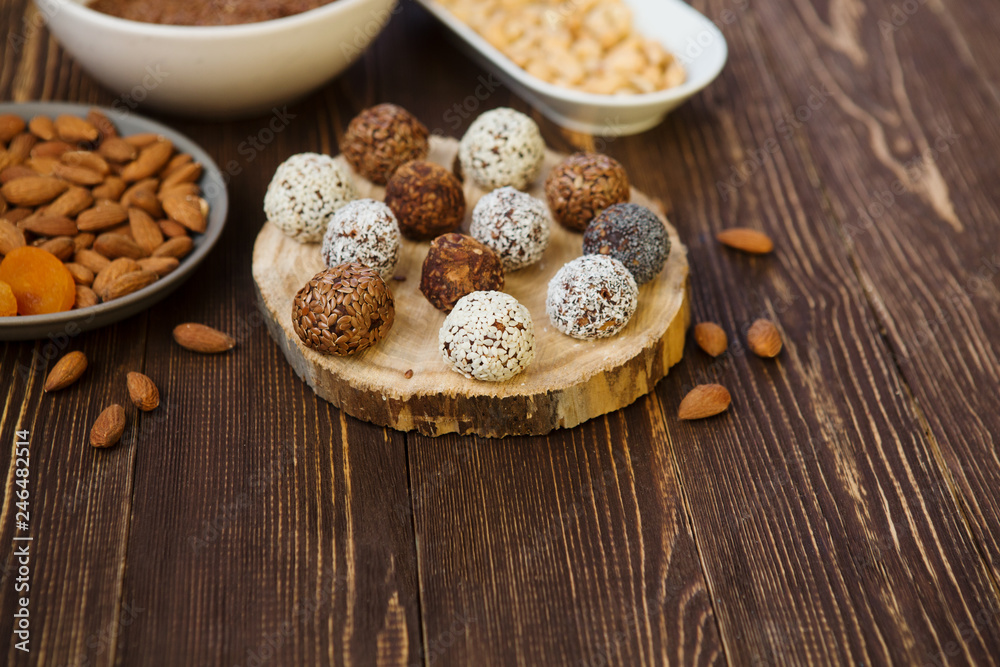 the vegan of handmade candy and ingredients on a wooden background. Fitness sweets. candies without sugar. vegan snack. the vegan of handmade candy and ingredients on a wooden background. Fitness sweets. candies without sugar. vegan snack.