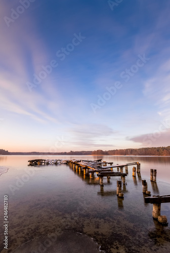 An old pier on the lake just before sunset in winter