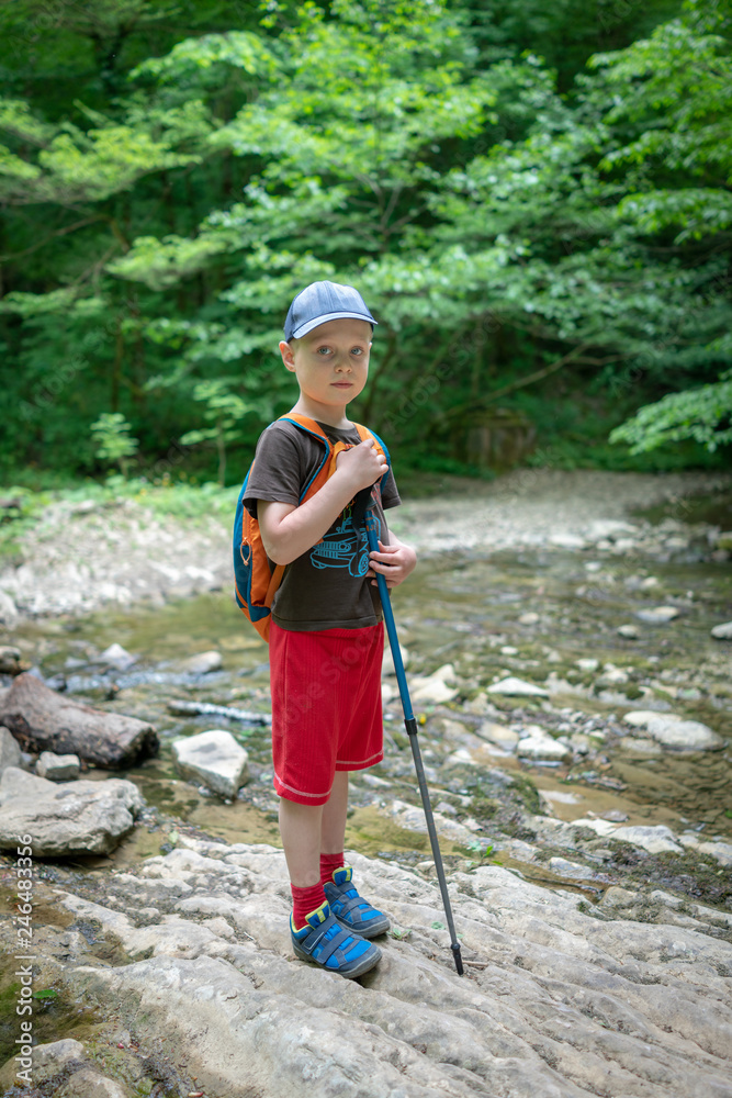 A boy traveler passes the stream ford