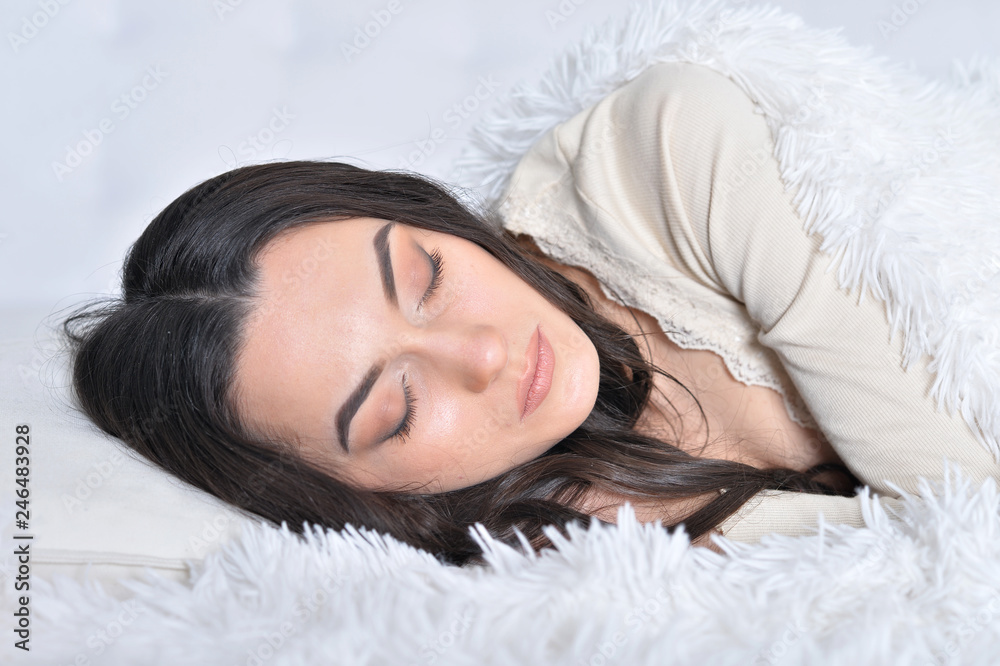 Portrait of beautiful young woman lying on soft bed Portrait of beautiful young woman lying on soft bed