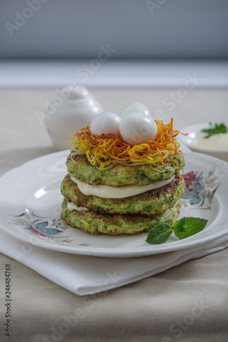 Courgette pancakes with eggs and carrots ot top, copy space