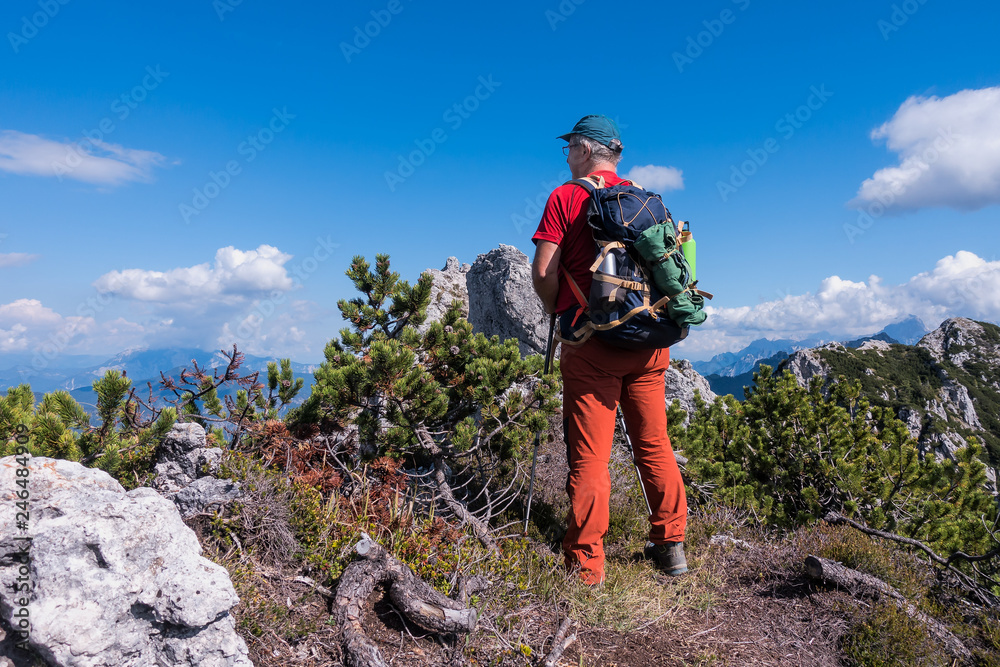 Hiker admire the mountain panorama of the peak.