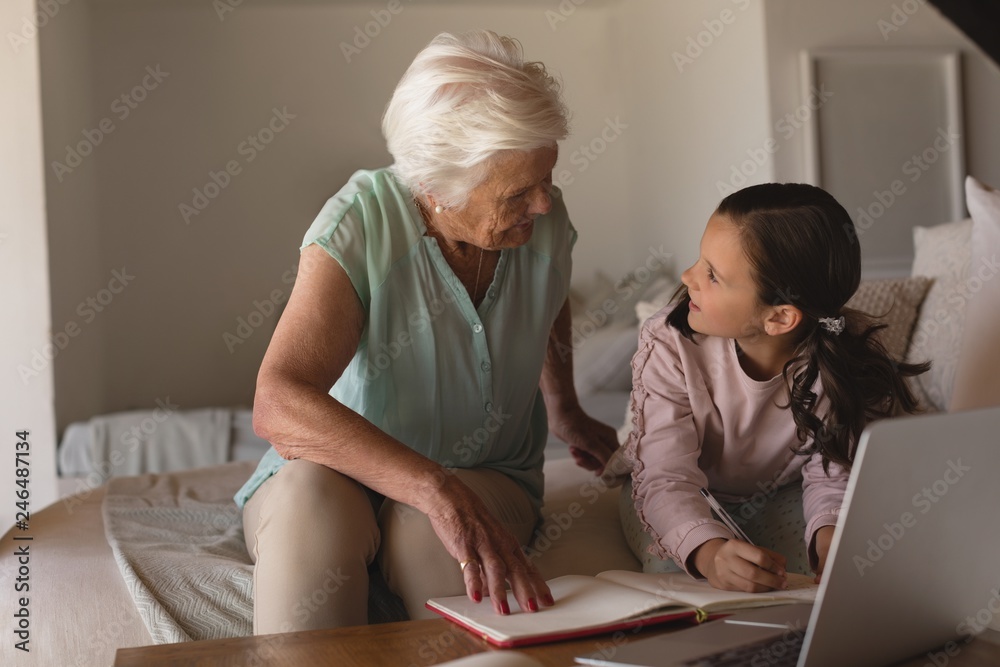 Grandmother helping her granddaughter with homework Grandmother helping her granddaughter with homework