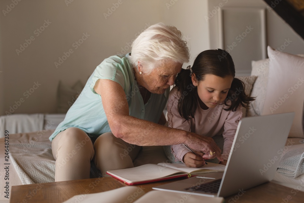 Grandmother helping her granddaughter with homework Grandmother helping her granddaughter with homework