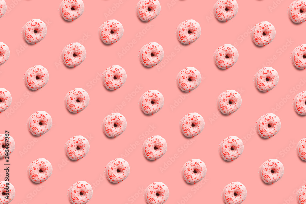 Sweet and tasty donuts with colorful icing and powder, like a pattern on a bright pastel color background. Homemade dessert and baking concept. Sweet and tasty donuts with colorful icing and powder, like a pattern on a bright pastel color background. Homemade dessert and baking concept.