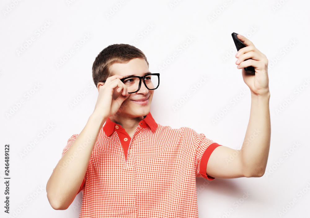 lifestyle and people concept: Photo of handsome man smiling on camera taking selfie isolated over white background lifestyle and people concept: Photo of handsome man smiling on camera taking selfie isolated over white background