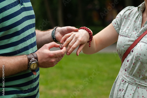 A man puts a ring on women finger