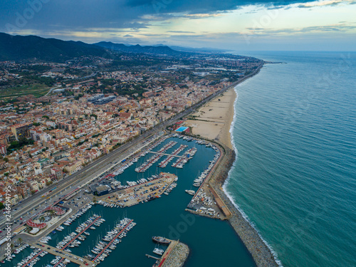 Aerial photo of sea port and a yacht club of Montgat at sunset, east of Barcelona, Spain
