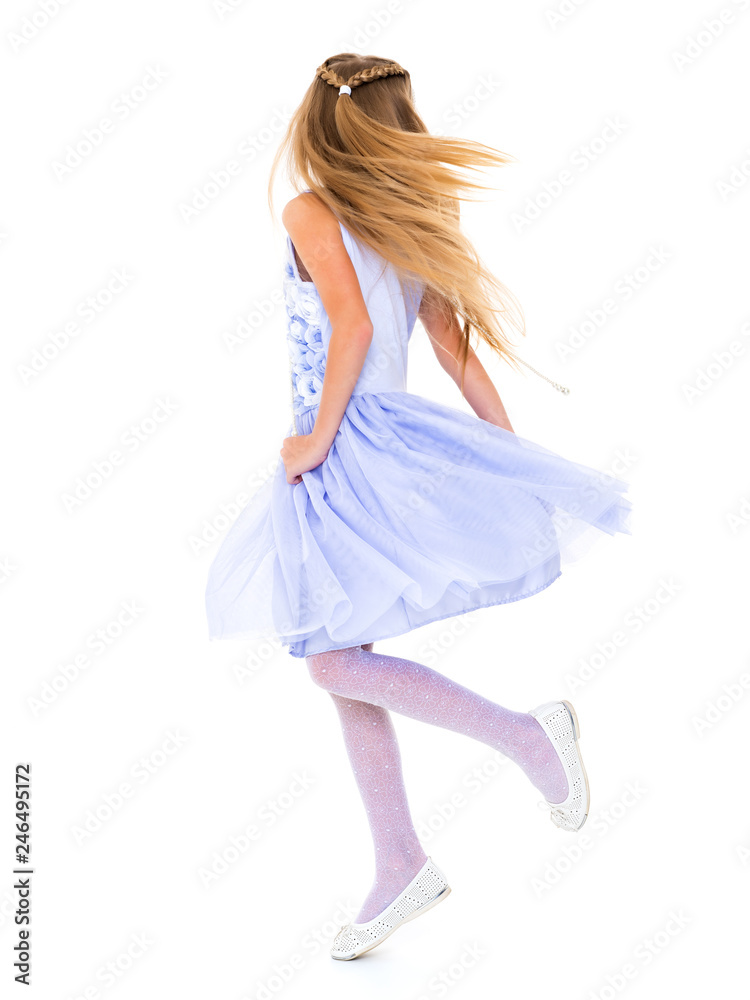 A little girl in a dress is spinning. A little girl in a dress is spinning.