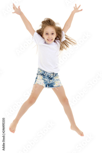 A little girl in a pure white t-shirt is jumping. The concept of