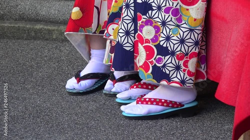 Feet of girls in traditional Japanese garment & footwear.