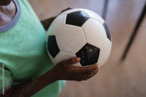 Schoolboy holding football in classroom © wavebreak3