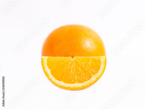 Juicy fresh orange in front of him a slice of orange. Close photo