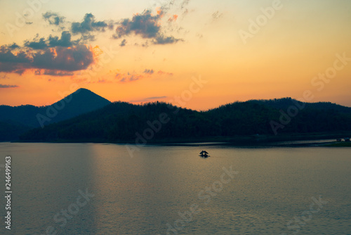 twilight sky river sunset yellow color landscape lake evening time clouds and mountains © Bigc Studio