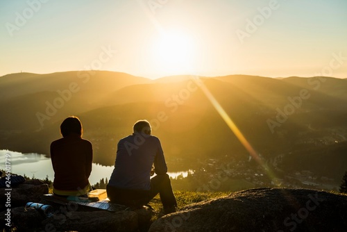 Older couple at Hochfirst with view to Titisee and Feldberg at sunset, near Neustadt, Black Forest, Baden-Wurttemberg, Germany, Europe photo